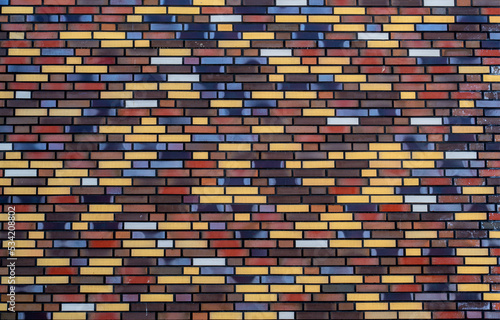Background from wall of multicolored bricks 