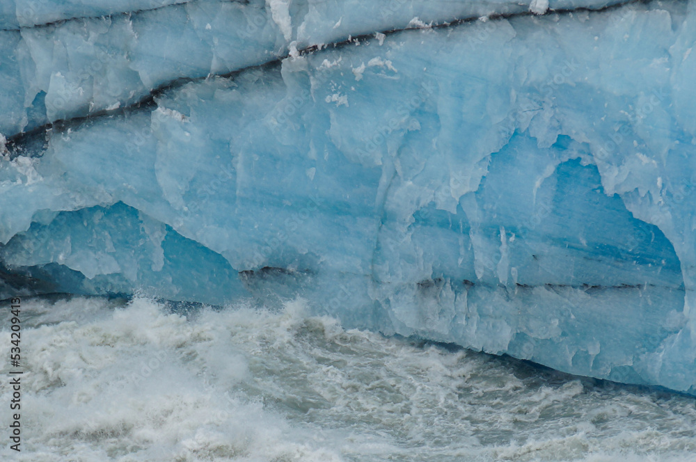 texture and background of glacier ice walls crossed by black lines of land.