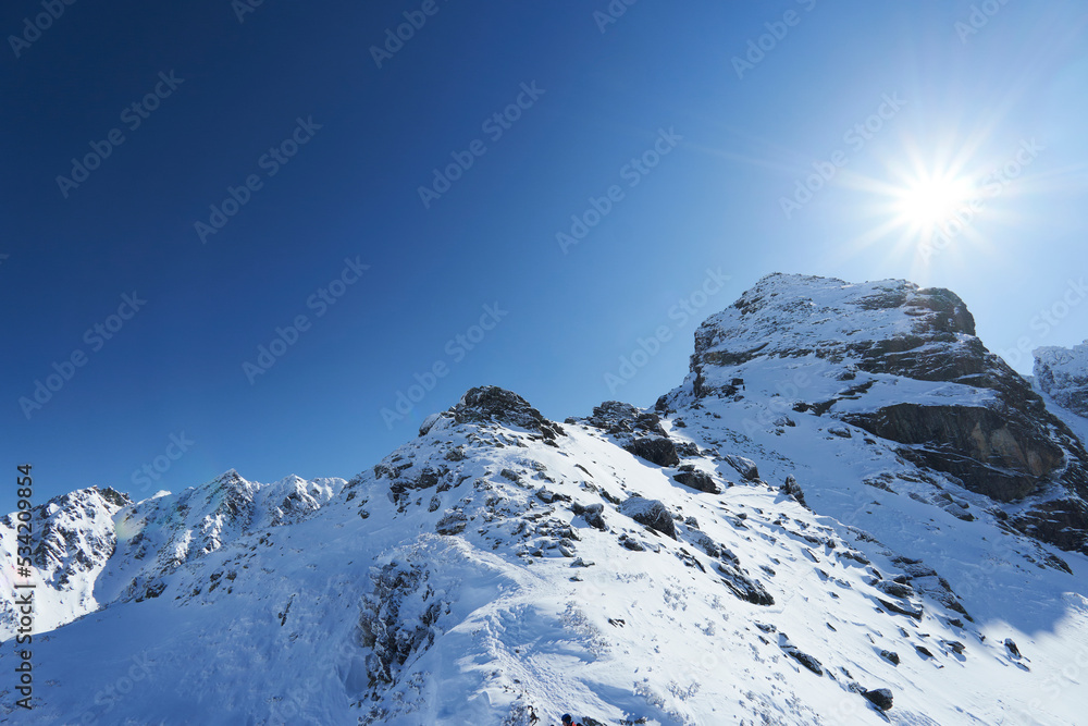 Beautiful view of Koscielec Peak - "Kościelec", High Tatra Mountains, Carpathian, Poland. The sun is shining over the top of the mountain. View from the Karb Pass. - obrazy, fototapety, plakaty 