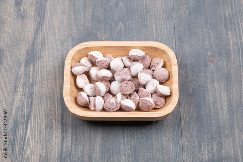 Bunch of small biscuits on wooden plate photo