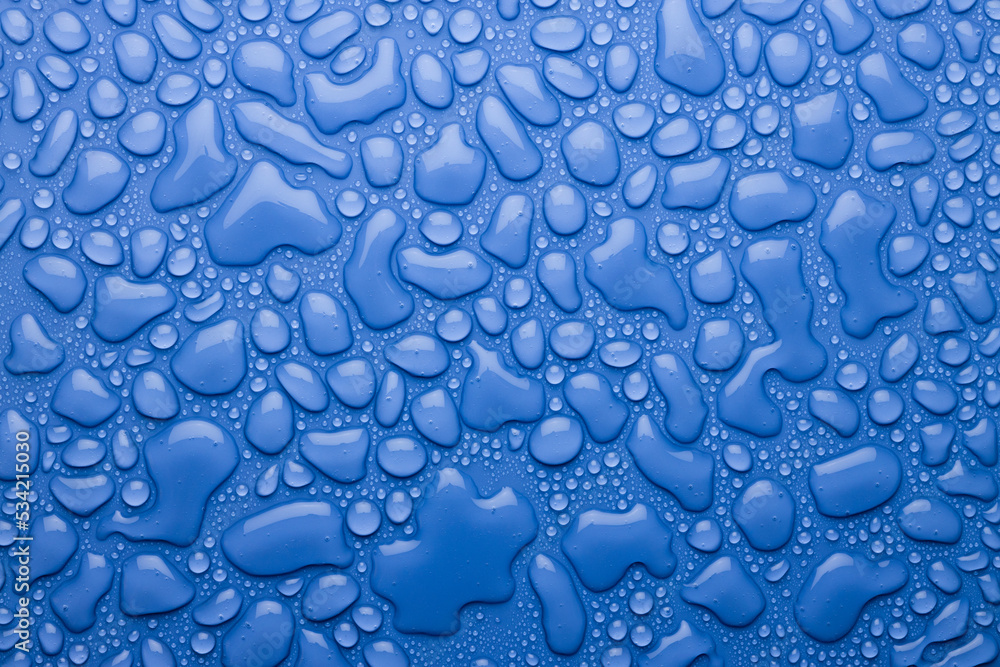 Water drops on bright fresh blue background as colorful pattern with glossy droplets and gradient, top view. Water drops on bright fresh blue background as colorful pattern with glossy droplets and gradient, top view.
