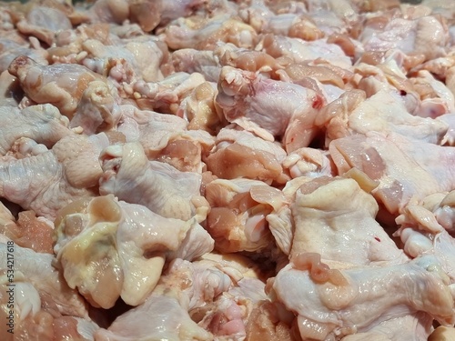 parts of raw chicken meat on ice for sell in a supermarket in Thailand.