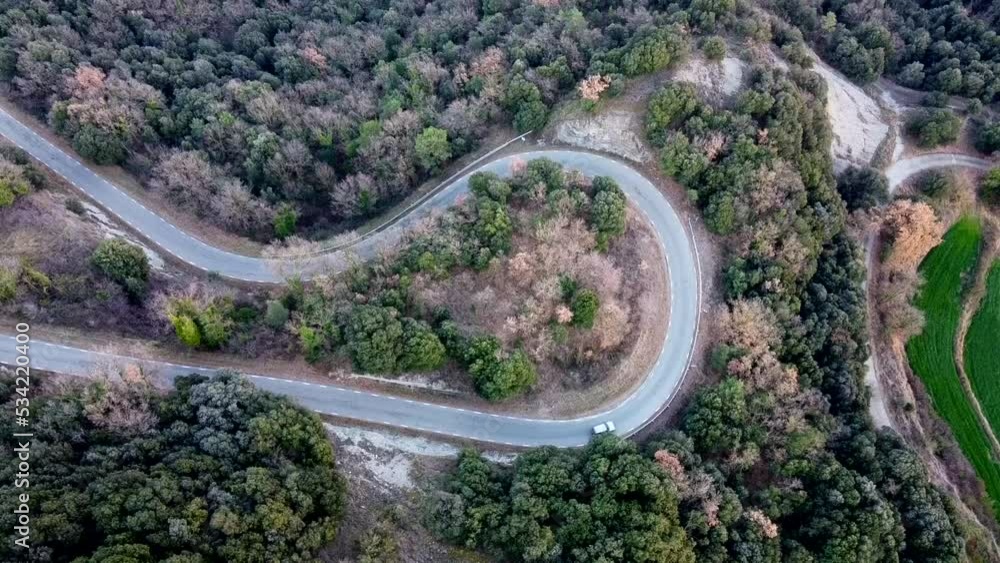 Birds eye view car driving on twisting snaking road in Catalonia mountains Birds eye view car driving on twisting snaking road in Catalonia mountains