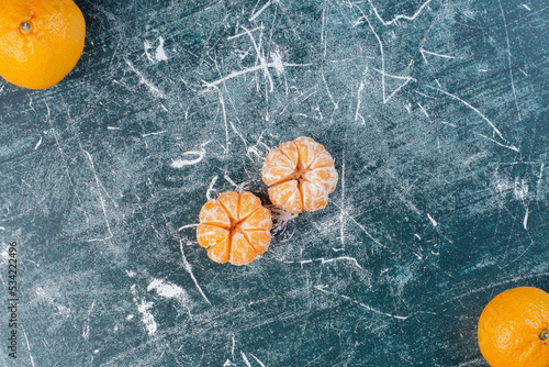 Mandarin oranges peeled on a blue background photo