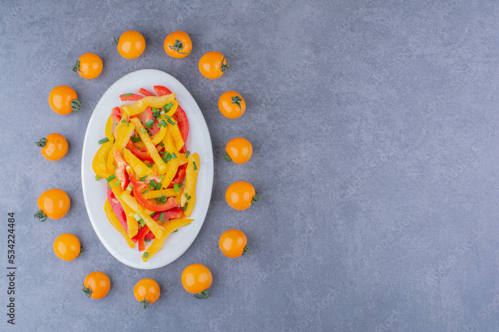 Chopped colorful bell pepper salad with cherry tomatoes aside