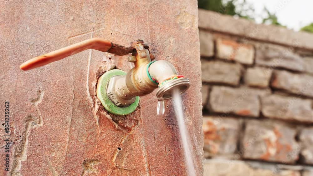 Water flows out of the metal connecting joint between the rubber hoses