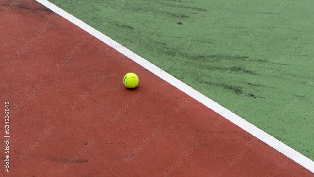directly above shot of tennis court and yellow tennis ball