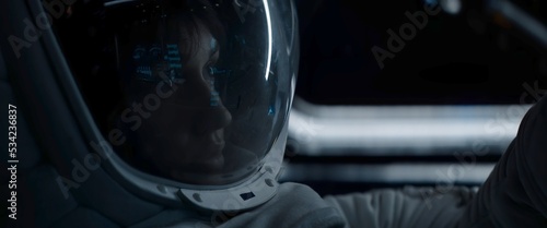 Portrait of Caucasian female astronaut inside spaceship cockpit. Sci-fi space exploration concept. Moon mission
