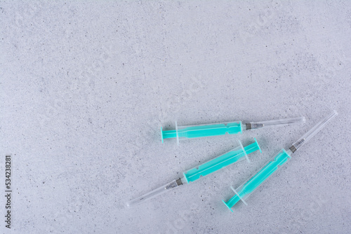 Several empty syringes on marble background