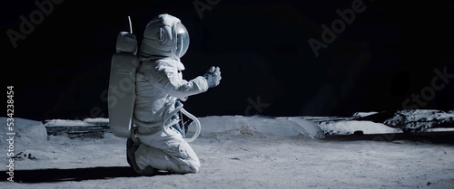 Full portrait of Caucasian female lunar astronaut finds something and kneels while exploring Moon surface