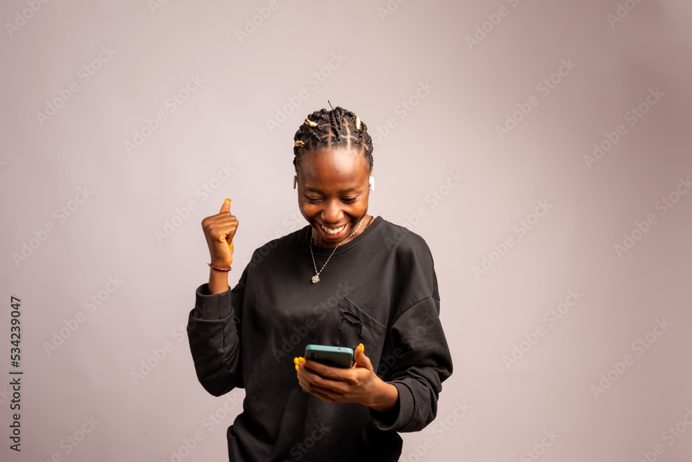 Happy excited model using online app on cellphone Happy excited model using online app on cellphone