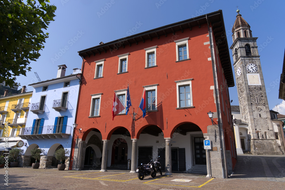 Red town hall at village of Ascona, Canton Ticino, on a sunny summer day. Photo taken July 24th, 2022, Ascona, Switzerland.