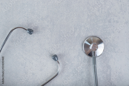 Black stethoscope isolated on gray background