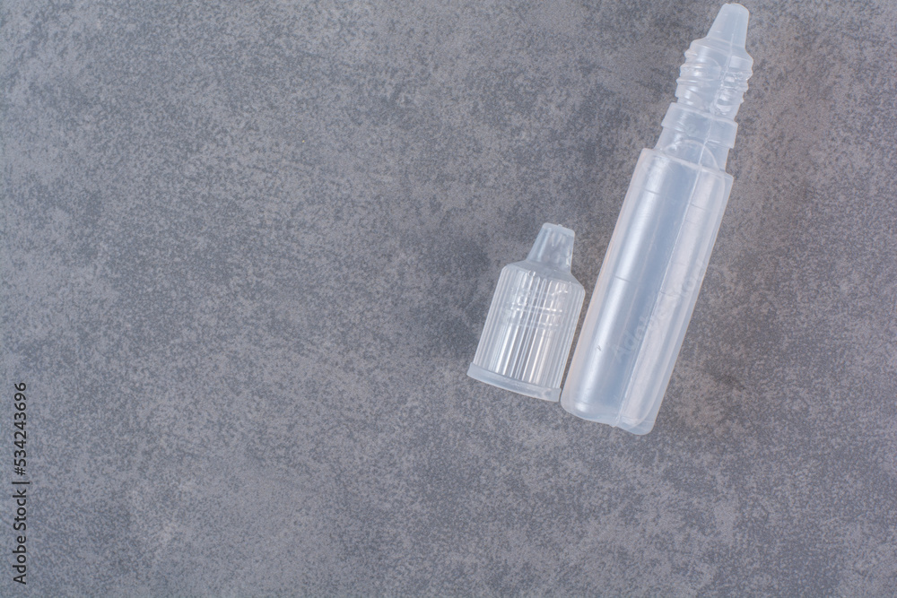 Naklejka premium Plastic parts of syringe on marble background