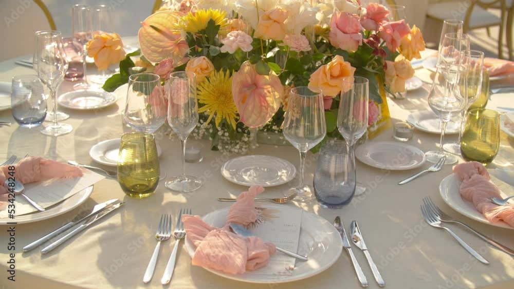 Table with tablecloth, beautiful serving of white dishes, fresh flowers, dinner in a restaurant Table with tablecloth, beautiful serving of white dishes, fresh flowers, dinner in a restaurant