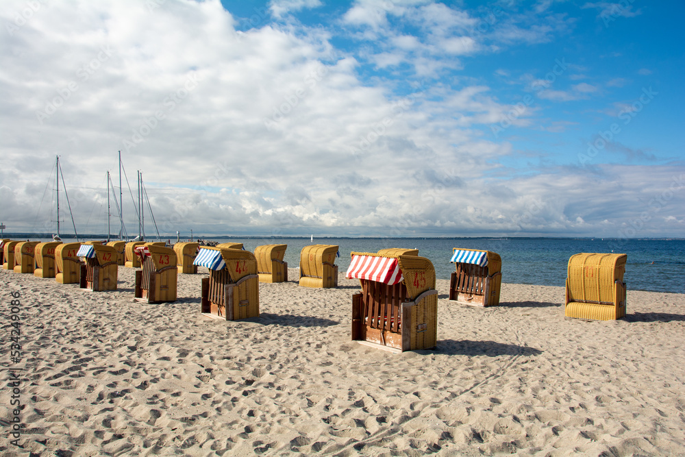 Beach chairs and ship mast at Timmendorf Strand on the Baltic Sea, Poel Island, Germany Beach chairs and ship mast at Timmendorf Strand on the Baltic Sea, Poel Island, Germany