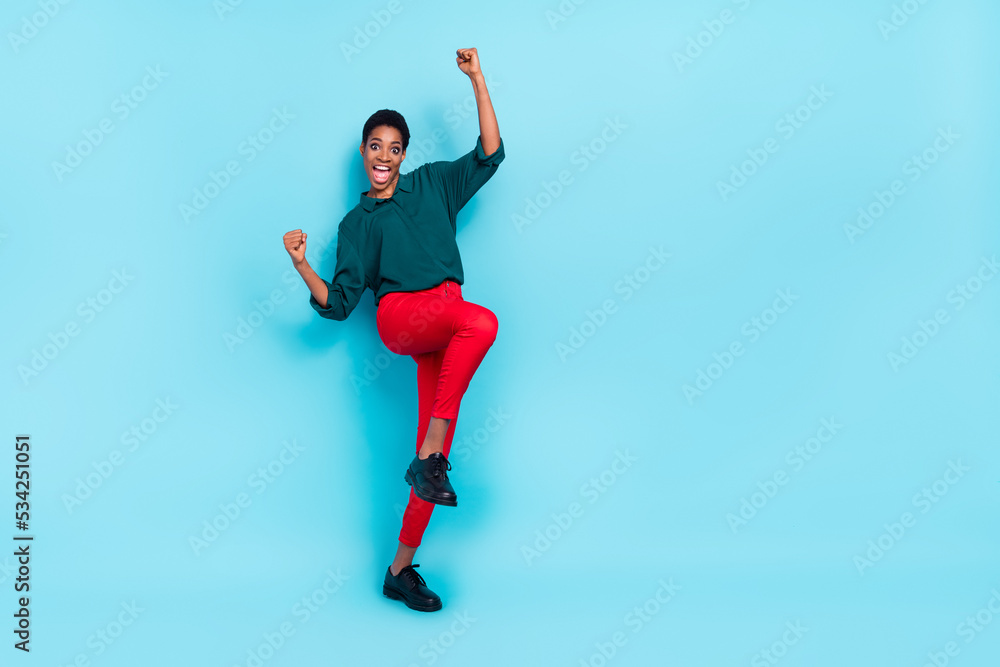 Full length body size view of attractive cheerful lucky woman dancing rejoicing isolated over bright blue color background