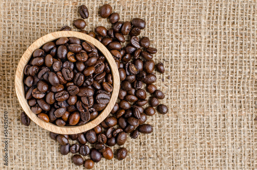 The coffee beans in the bowl on the hessian sack  for background , texture , copy text, Love coffee concept