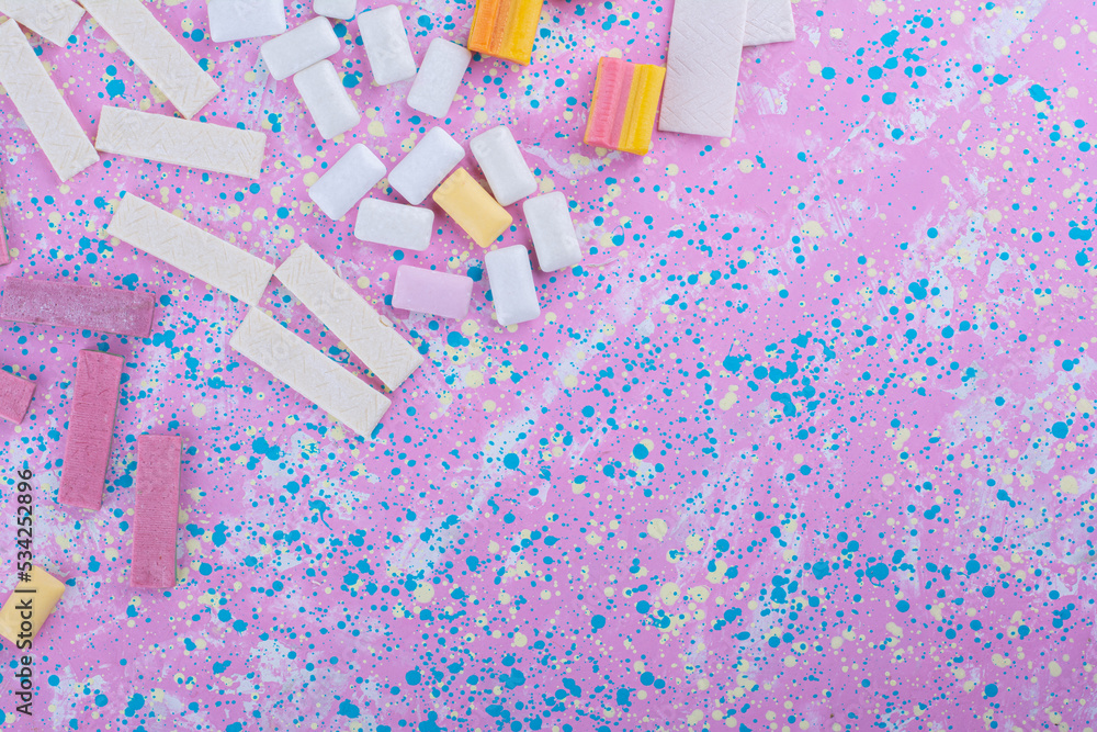Different types of chewing gums arranged into messy lines on a colorful