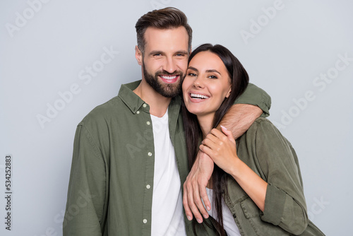Portrait of attractive tender sweet cheerful couple cuddling romance time enjoying isolated over grey pastel color background