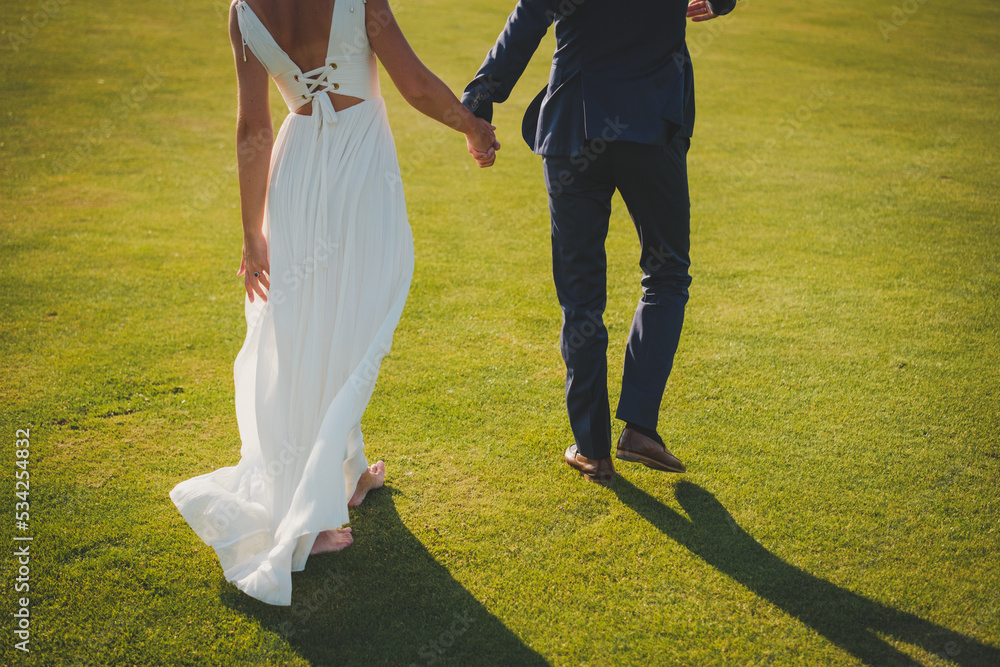 Obraz premium bride and groom walking