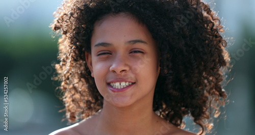 Beautiful preteen girl child portrait smiling outside, black African descent