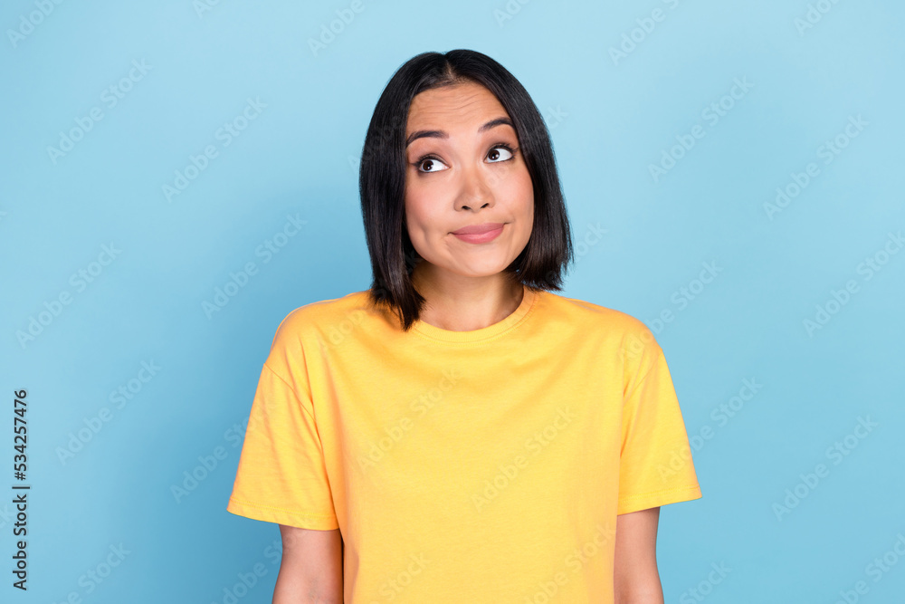 Portrait of nice pretty lovely woman with bob hairdo dressed yellow t-shirt guilty look empty space isolated on blue color background Portrait of nice pretty lovely woman with bob hairdo dressed yellow t-shirt guilty look empty space isolated on blue color background