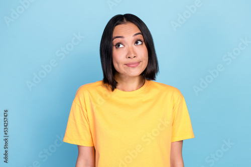 Portrait of nice pretty lovely woman with bob hairdo dressed yellow t-shirt guilty look empty space isolated on blue color background