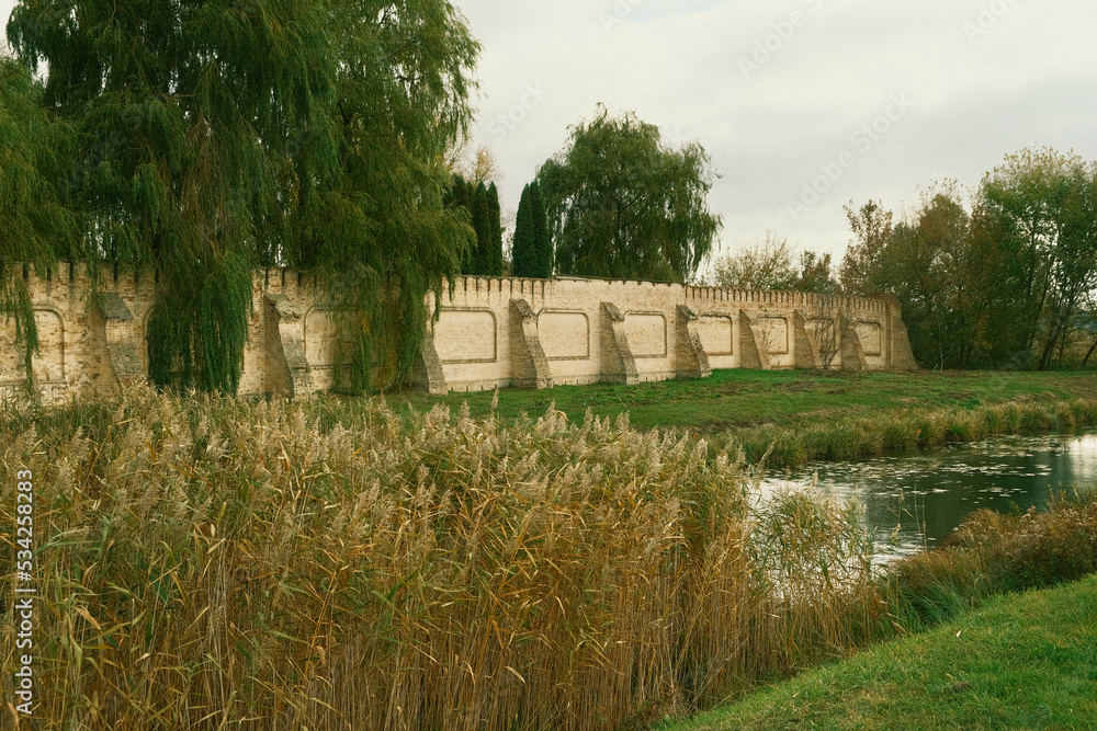 Ancient Cossack fortress. Brick walls, gates, a moat and a bridge leading to the fortress. Around the river with reeds, and brick walls for defending. Ancient Cossack fortress. Brick walls, gates, a moat and a bridge leading to the fortress. Around the river with reeds, and brick walls for defending.