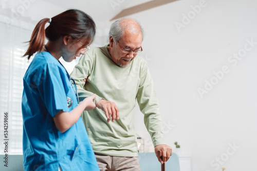 Obraz na płótnie Asian senior elderly man patient doing physical therapy with caregiver
