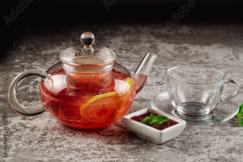 Tea from strawberry jam in a glass teapot