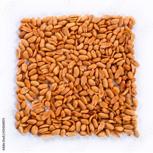 pile of spiced peanuts isolated close up on white background 