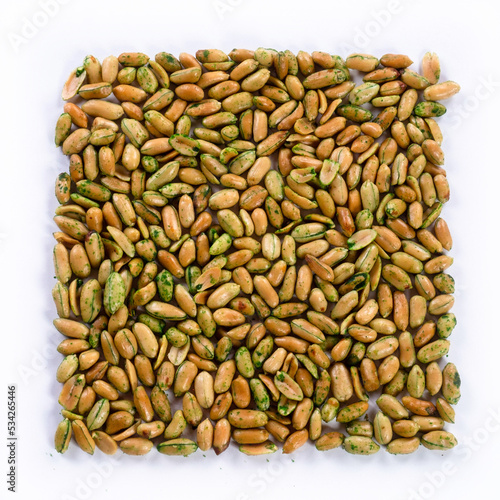 pile of salted peanuts with wasabi isolated close up on white background 