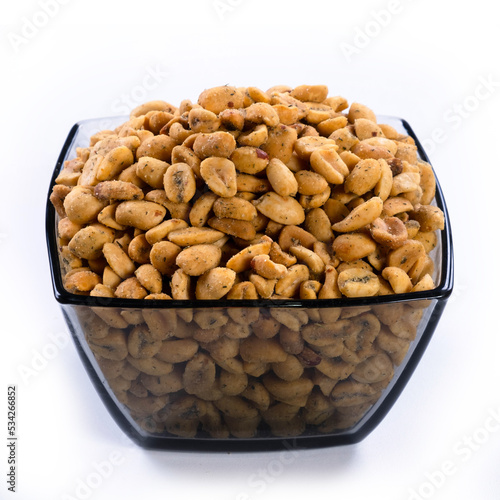 pile of spiced peanuts isolated close up on white background 