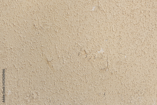 abstract background of an old shabby painted beige wall close up