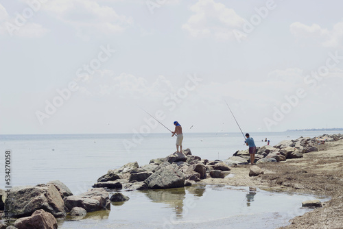 fishermen fishing with fishing rods on the sea catch fish