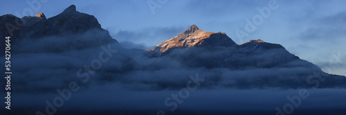 Sunlit peak of Mount Oldehore in early morning. photo