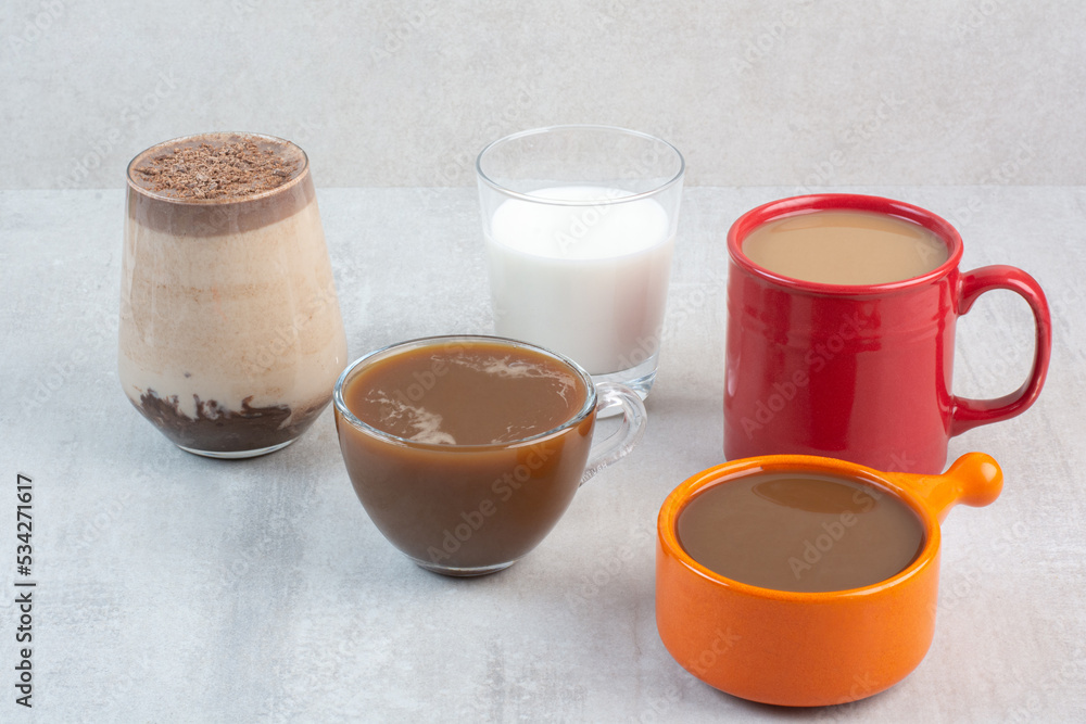 Various delicious coffee cups and milk on stone background Various delicious coffee cups and milk on stone background