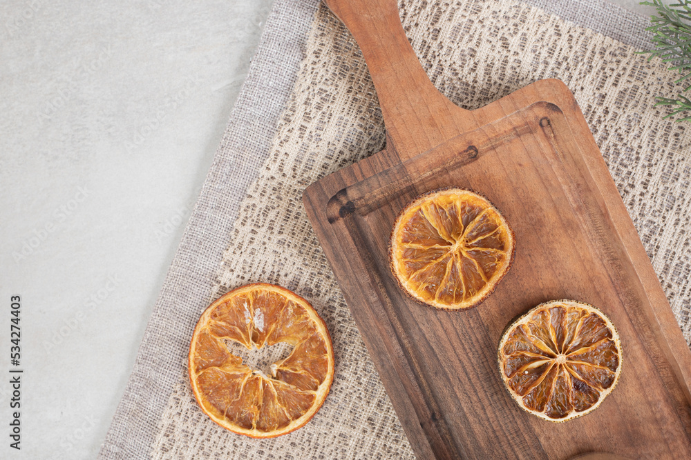 Dried orange slices on wooden board Dried orange slices on wooden board