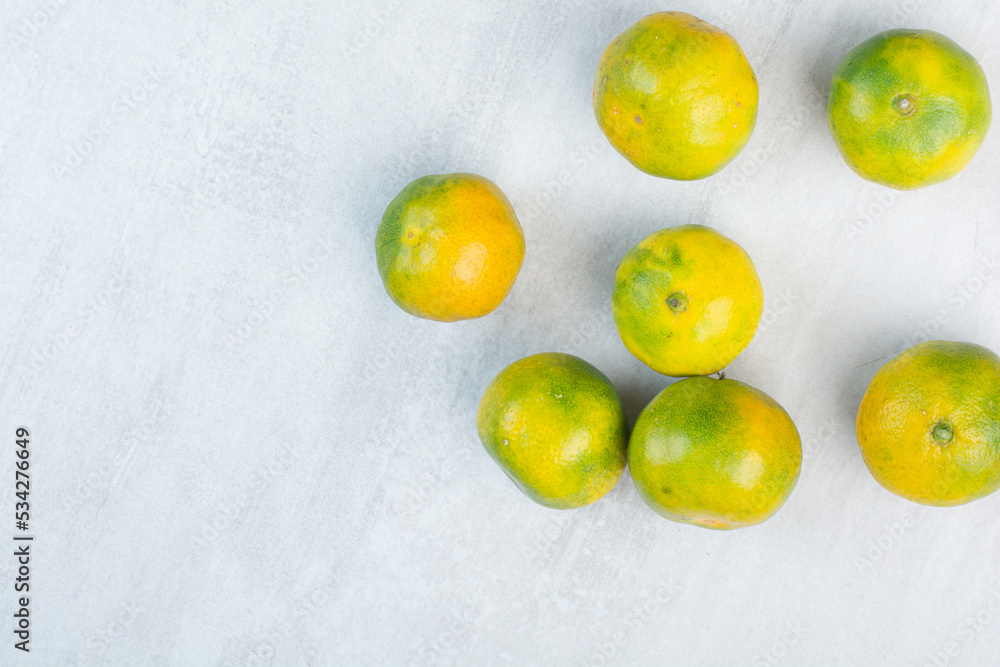 Bunch of fresh mandarines on stone background Bunch of fresh mandarines on stone background