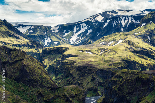Green mountain canyon with snow covered and river in Icelandic Highlands photo
