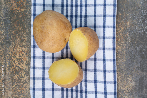 Boiled delicious whole potatoes on tablecloth