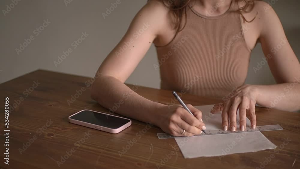 girl draws a line with a pencil and a ruler girl draws a line with a pencil and a ruler