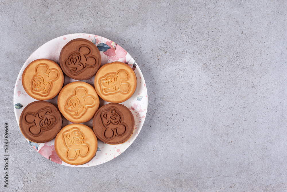 Fototapeta premium Tart cookies on decorated plate on marble background