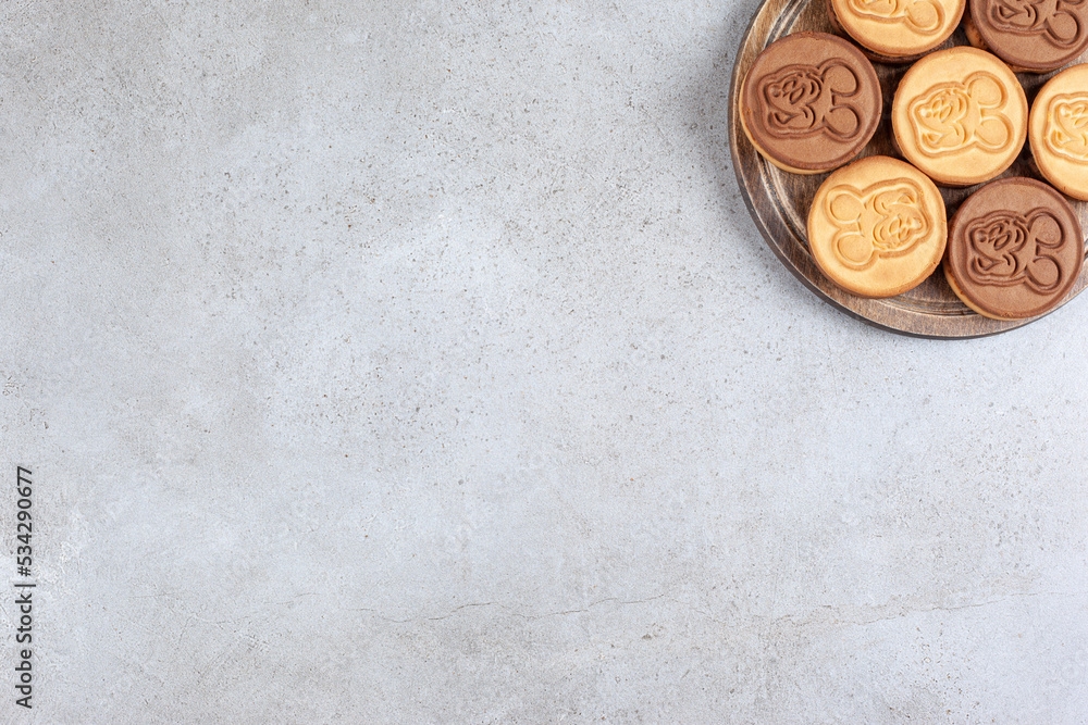 Decorated cookies on wooden board in marble background Decorated cookies on wooden board in marble background