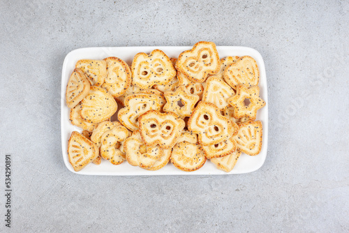 Biscuits on a white plate on marble background