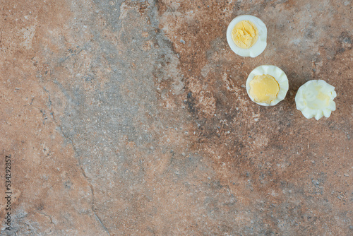Boiled sliced eggs on marble background