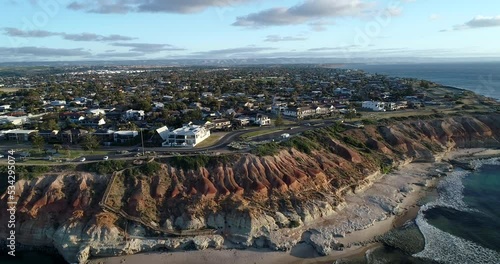 Reverse tracking aerial view of The Onkaparinga River and city of Port Noarlunga with wooden walkway leading to Noarlunga beach, Adelaide, South Australia,Australia