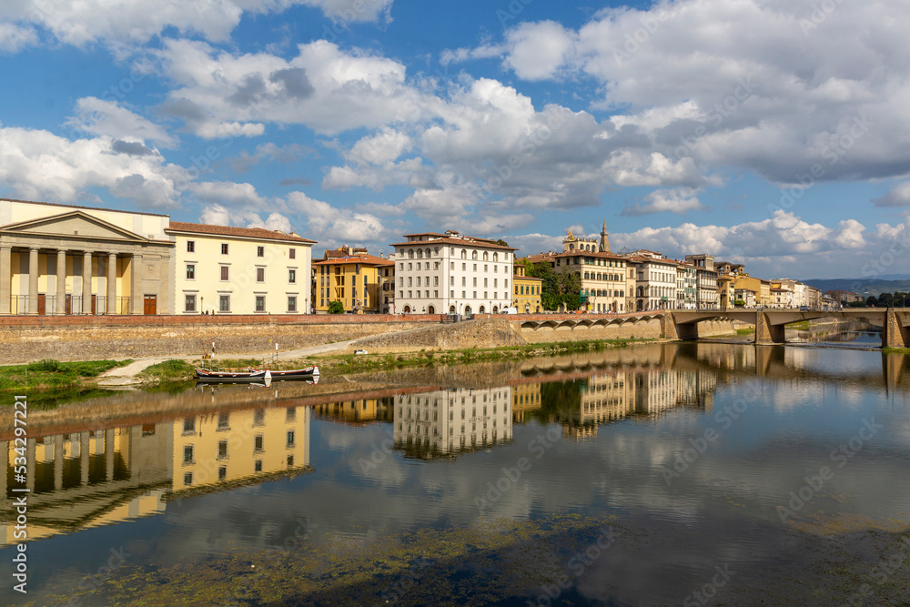 Beautiful reflection of historical houses along the Arno river in Florence