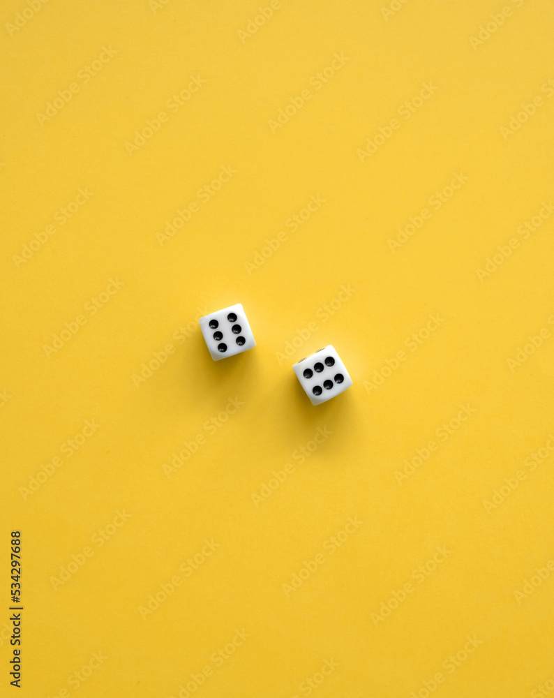 Yellow Background With White-Black Dice. Simple Minimalist Composition with Two Dice with Six Dots on Each. No Text. Symbol of Gambling or Big Luck. Yellow Background With White-Black Dice. Simple Minimalist Composition with Two Dice with Six Dots on Each. No Text. Symbol of Gambling or Big Luck.